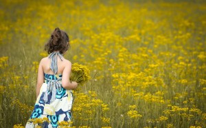 sad_girl_in_yellow_flowers_field